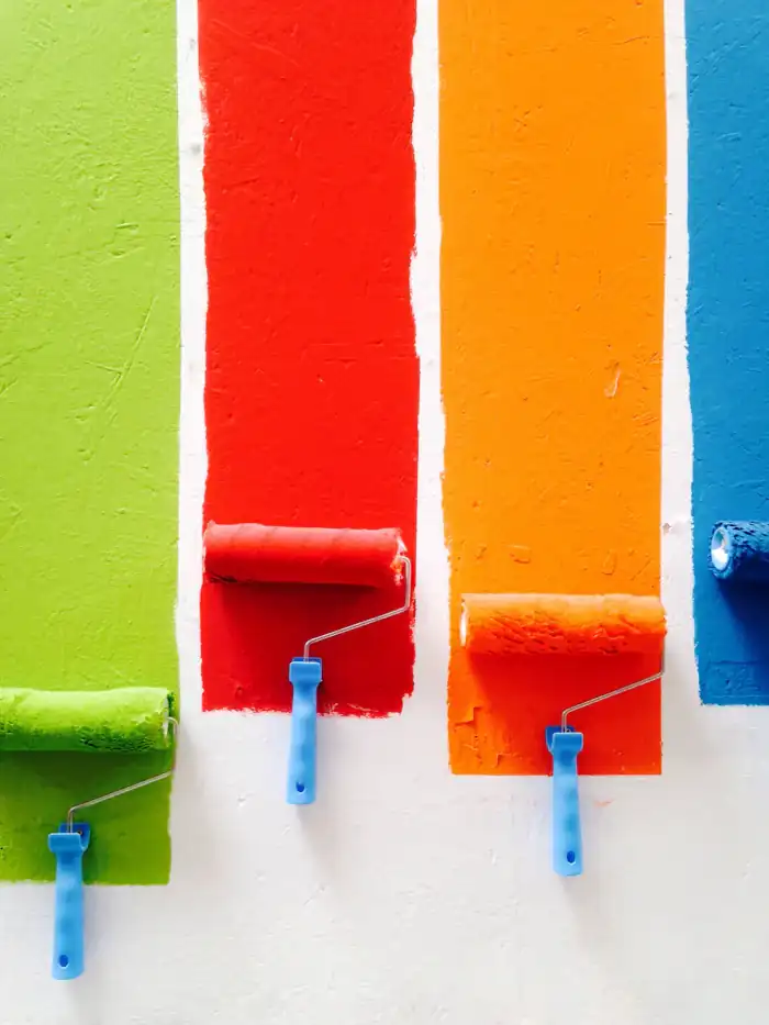 Paint rollers with bright colour strokes
